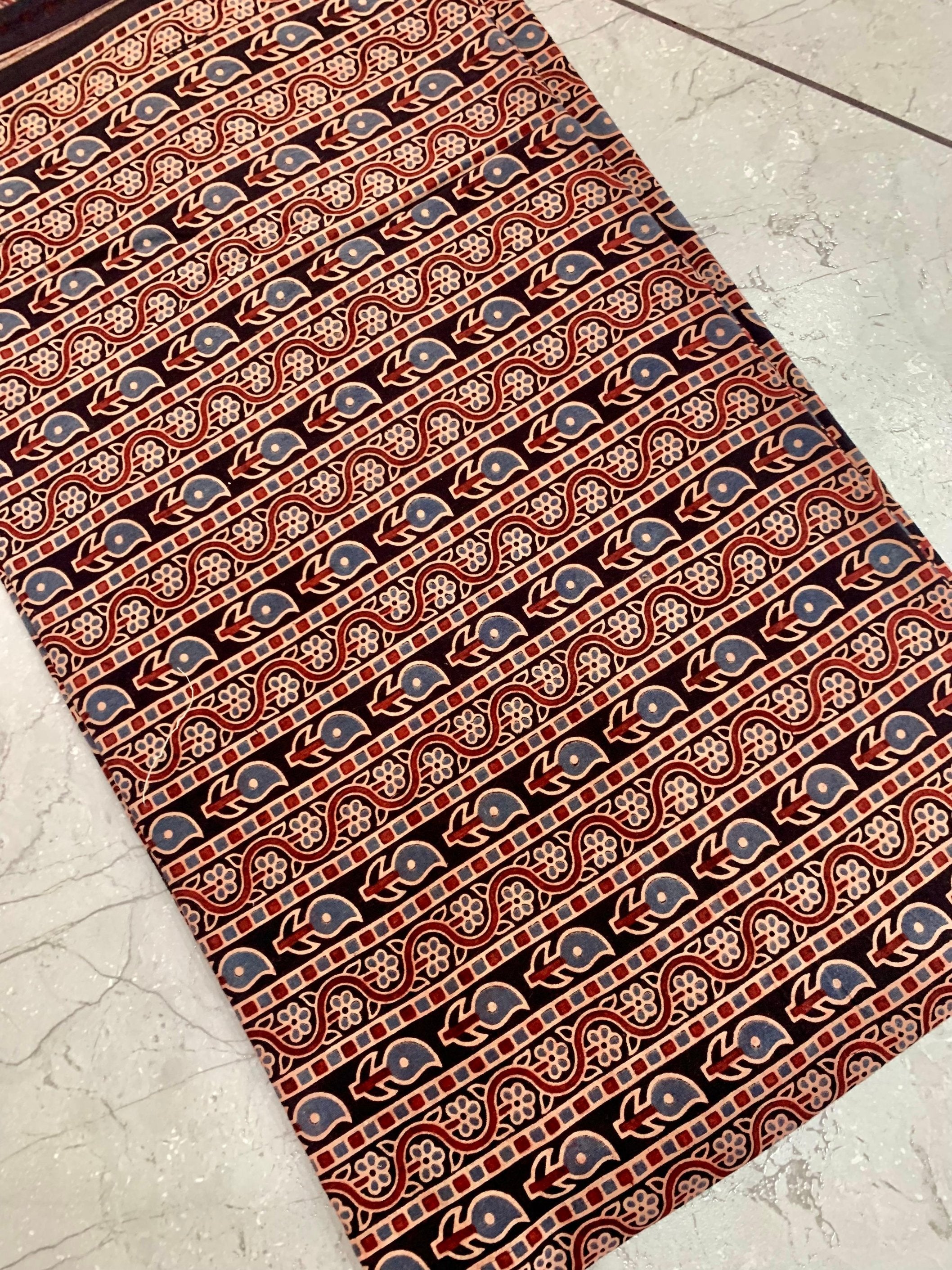 Black paisley Ajrakh handblock printed pure cotton fabric wholesale with intricate traditional teardrop motifs.